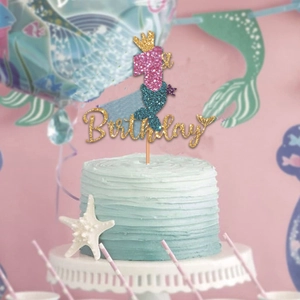 Detail of glitter mermaid cake topper with number one and crown for first birthday