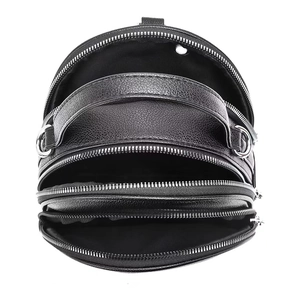 Close-up of black litchi pattern backpack showing three separate zipper compartments