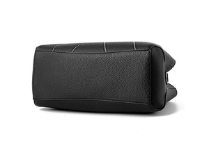 Detail of black lychee leather handbag with contrast white stitching and wide base