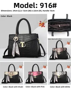 Detail view of large snake pattern handbag with dimensions 29x12x22cm and metal lock closure