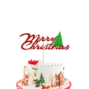 Close-up of red and green glitter Merry Christmas cake topper on white cream frosting