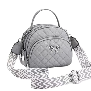 Grey quilted crossbody bag for women with silver bow detail and chevron strap