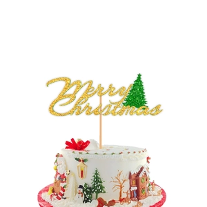 Close-up of glittery Merry Christmas cake topper with green tree on a frosted cake