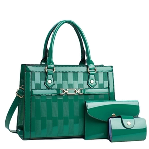 Glossy emerald green three-piece handbag set with textured geometric weave pattern