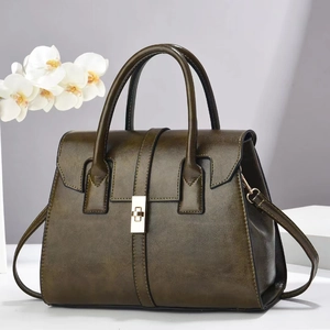 Olive green top handle bag with gold metal clasp and detachable shoulder strap for women