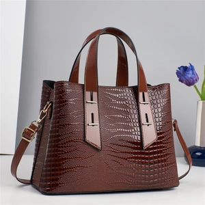 Elegant crocodile pattern brown tote bag with metal hardware and adjustable strap