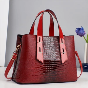 Red crocodile pattern tote bag with gold hardware and detachable shoulder strap