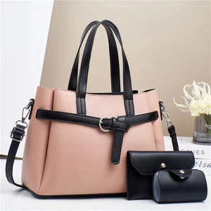 Three-piece women's set with pink pebbled tote, black wallet and round coin purse