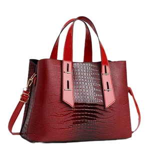 Deep red crocodile embossed tote bag with gold hardware and dual handles