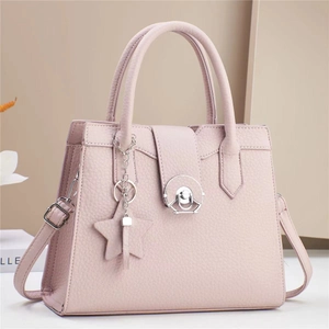 Minimalist light pink leather crossbody tote bag with silver star charm and handle