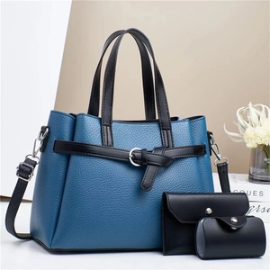 Detailed set of blue and black pebbled leather handbags with silver hardware details