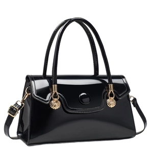Elegant black patent leather handbag with gold shell charm and adjustable shoulder strap