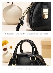 Detail of gold metal buckle and round handle on black oil-wax leather handbag