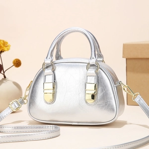 Detailed shot of silver mini handbag with metallic texture and gold hardware details