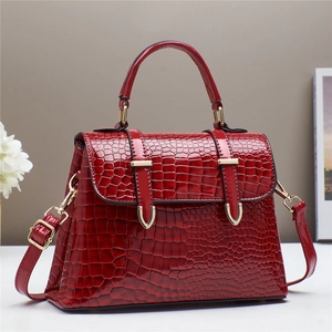 Elegant red crocodile pattern handbag with gold hardware and adjustable strap for women