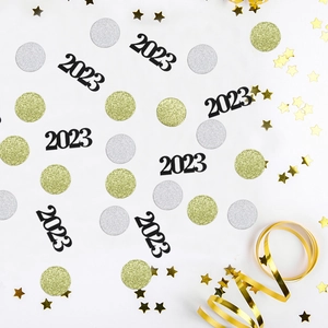 New Year party table confetti set with gold stars, silver circles and black 2023 shapes