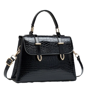 Glossy black crocodile pattern trapezoid handbag with gold hardware and top handle
