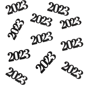 Detailed close-up of black 2023 cutout confetti for New Year Eve party table decoration
