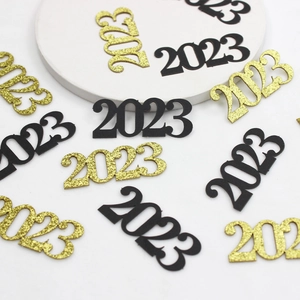 Close-up of 2023 number confetti in gold glitter and black for New Year party decor