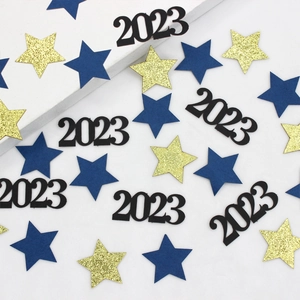 Close-up of 2023 number confetti with gold glitter stars and blue paper stars decor