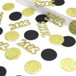 Close-up of gold 2023 glitter confetti with black and gold round sequins for New Year party