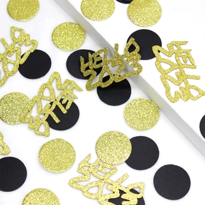 Close-up of golden glitter Hello 2023 cutouts and black circular New Year party confetti