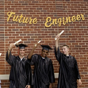 Glittery gold Future Engineer banner for graduation party decor over a red brick wall