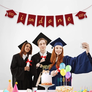 Burgundy graduation banner with golden I am done text and glittery mortarboard charms