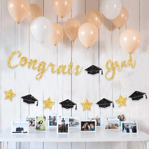 Glittery Congrats Grad banner with black mortarboard and gold stars for graduation party décor