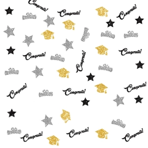 Detail of graduation table confetti featuring glittery black congrats and gold caps