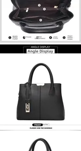 Detail view of large black leather tote showing multiple inner compartments and gold zippers