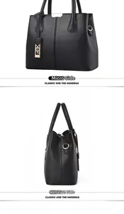 Classic black handbag detail with pebbled leather texture and side metal ring accents