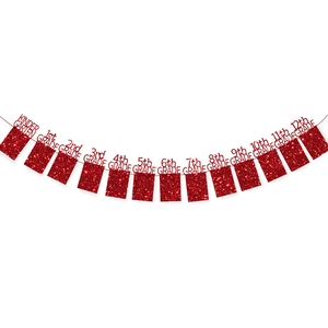 Detail of red glitter graduation banner featuring grades from Kindergarten to 12th Grade