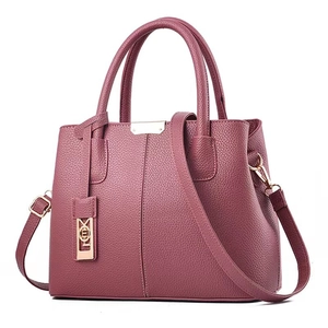 Burgundy lychee grain leather handbag with dual handles and gold-tone metal hardware