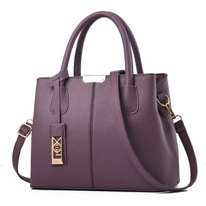 Deep purple pebbled leather tote bag with gold hardware and detachable shoulder strap