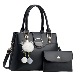 Black leather handbag set with tote, small clutch, and decorative tassel accessory