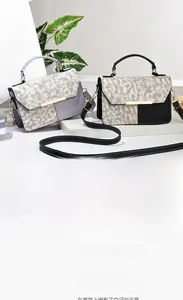 Detail of woven texture flap and metallic closure on elegant leather crossbody bags