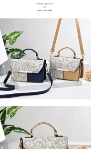 Detail of color-block crossbody bag with woven texture flap and gold metal hardware