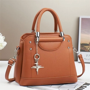 Brown lychee grain leather crossbody bag with silver hardware and star pendant