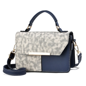 Blue and white woven textured crossbody bag with golden hardware and round handle