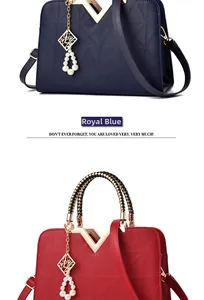 Detail of royal blue and red handbags featuring geometric patterns and V-shaped metal buckles
