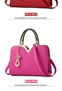 Detailed view of structured hand bags with geometric texture and pearl pendant detail