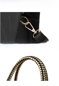 Detail of gold hardware and black-gold braided handle on a black PU leather handbag