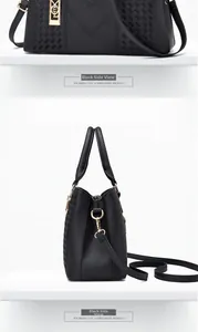 Detail of black pebbled leather handbag featuring V-stitching and woven texture details