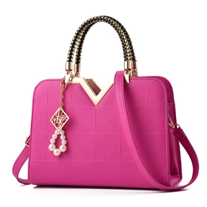 Magenta structured handbag with geometric embossing and golden V-shaped clasp handle