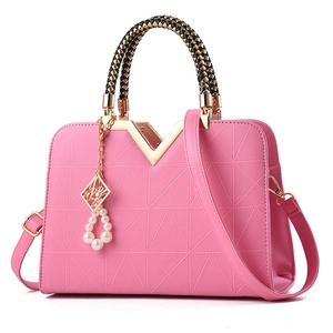 Pink top-handle bag with geometric embossed texture and braided black gold handles