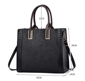 Detailed view of black embossed tote bag with size measurements 33x28x14cm