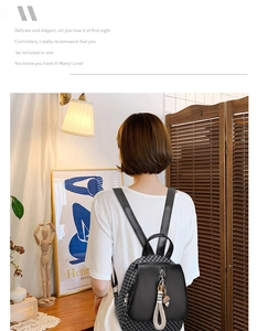 Detail of a black plaid pattern backpack on a model in a minimalist indoor setting