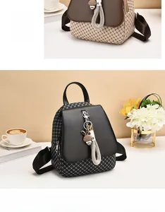 Detail of stylish mini backpack with flap design and cute rabbit charm attachment