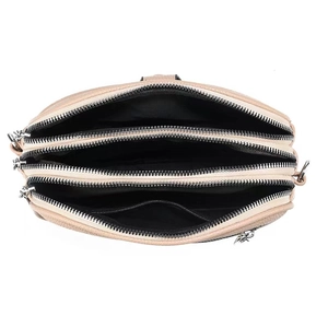 Detailed top view of a soft leather shoulder bag showing three main zipper compartments